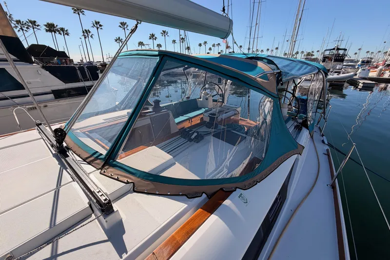 Leah Yacht Photos Pics 2014 Jeanneau Sun Odyssey 469 sailboat with blue canopy docked in marina.