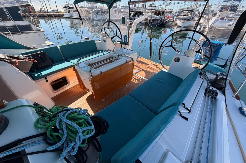 Leah Yacht Photos Pics 2014 Jeanneau Sun Odyssey 469 sailboat cockpit with teal seating and dual steering wheels.