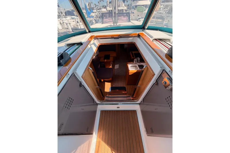 Leah Yacht Photos Pics Interior view of 2014 Jeanneau Sun Odyssey 469 sailboat, showcasing cabin and seating area.