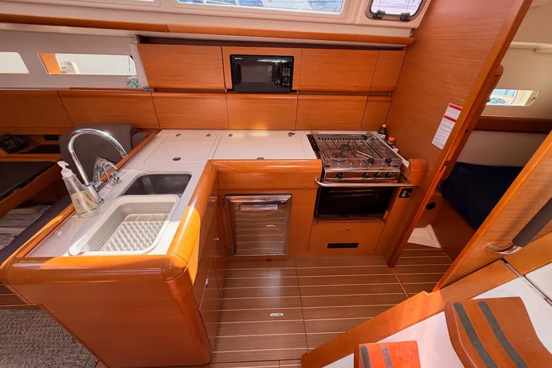 Leah Yacht Photos Pics 2014 Jeanneau Sun Odyssey 469 yacht kitchen with stove, sink, and microwave.