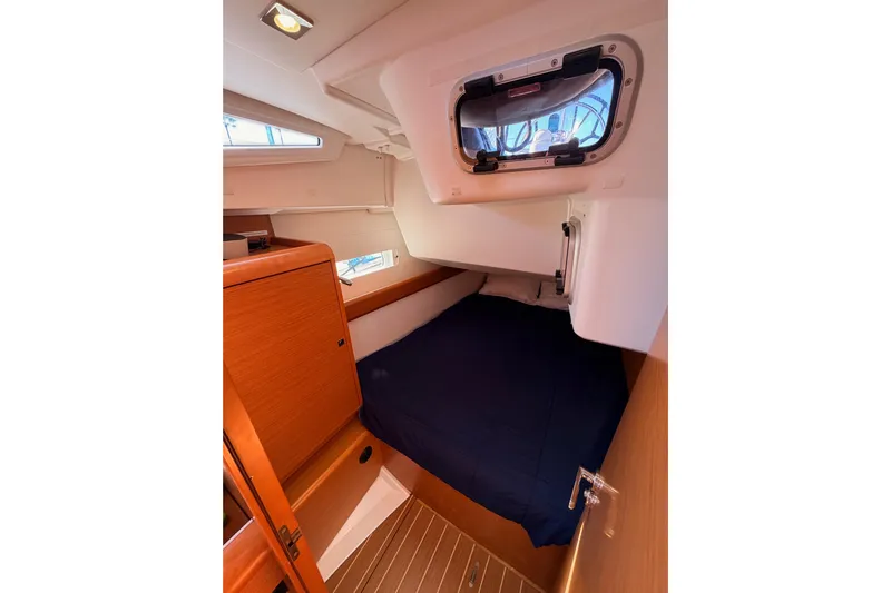 Leah Yacht Photos Pics Cozy cabin interior of 2014 Jeanneau Sun Odyssey 469 sailboat with wooden finishes.