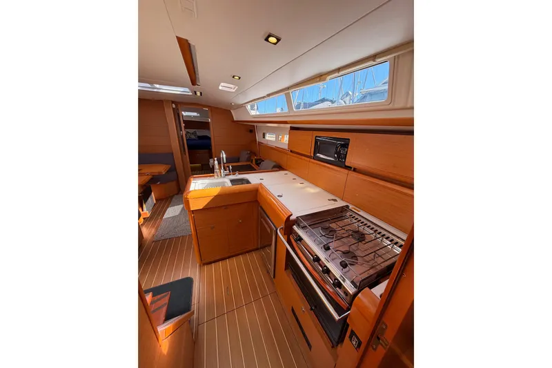 Leah Yacht Photos Pics Interior of 2014 Jeanneau Sun Odyssey 469 yacht, featuring a modern kitchen and dining area.