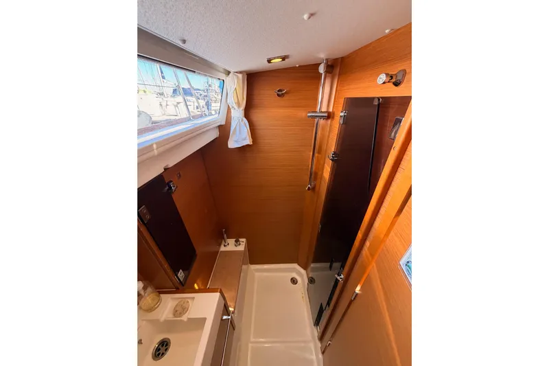 Leah Yacht Photos Pics Bathroom interior of 2014 Jeanneau Sun Odyssey 469 yacht, featuring shower and sink.