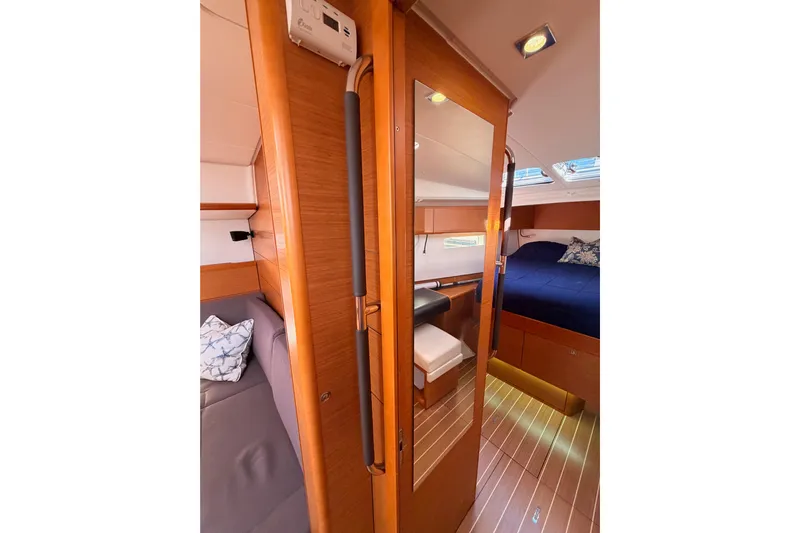 Leah Yacht Photos Pics Interior of 2014 Jeanneau Sun Odyssey 469 yacht, featuring cozy cabin and wooden finishes.