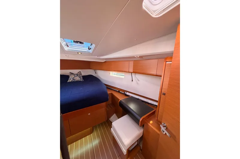 Leah Yacht Photos Pics Interior cabin of 2014 Jeanneau Sun Odyssey 469, featuring wood finish and cozy bedding.
