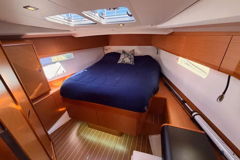 Leah Yacht Photos Pics Luxurious cabin interior of 2014 Jeanneau Sun Odyssey 469 yacht with cozy bed and wooden finish.