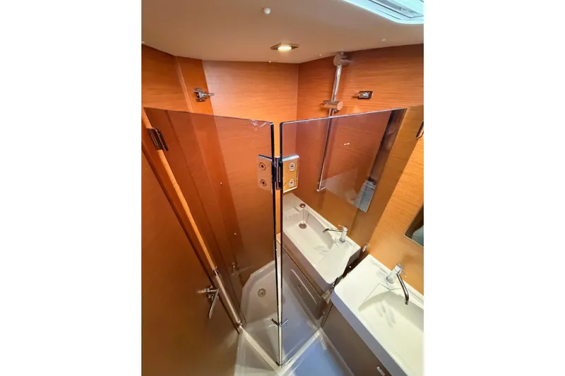 Leah Yacht Photos Pics Bathroom interior of 2014 Jeanneau Sun Odyssey 469 yacht with modern fixtures and wood paneling.