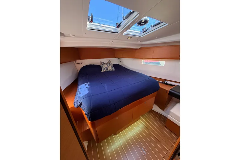 Leah Yacht Photos Pics Cozy cabin interior of 2014 Jeanneau Sun Odyssey 469 with skylight and wooden flooring.