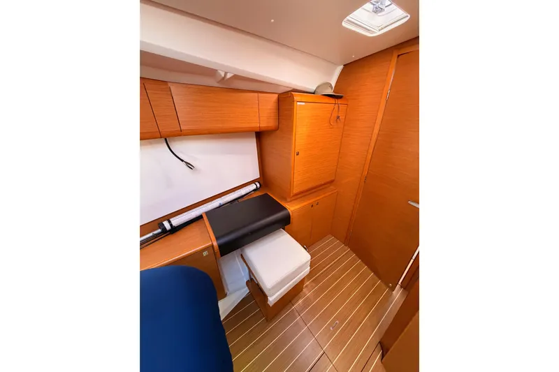 Leah Yacht Photos Pics 2014 Jeanneau Sun Odyssey 469 cabin interior with wooden cabinetry and flooring.