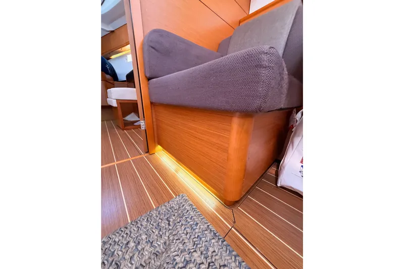 Leah Yacht Photos Pics Interior of 2014 Jeanneau Sun Odyssey 469 yacht with wooden flooring and cushioned seating.