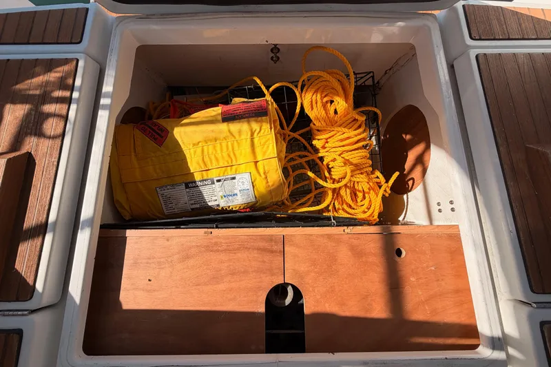 Leah Yacht Photos Pics Storage compartment on 2014 Jeanneau Sun Odyssey 469 with yellow rope and safety equipment.