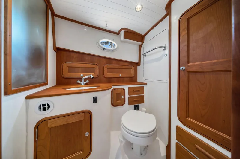 She's The One Yacht Photos Pics 2019 Hinckley Picnic Boat 34 bathroom with wood accents and modern fixtures.