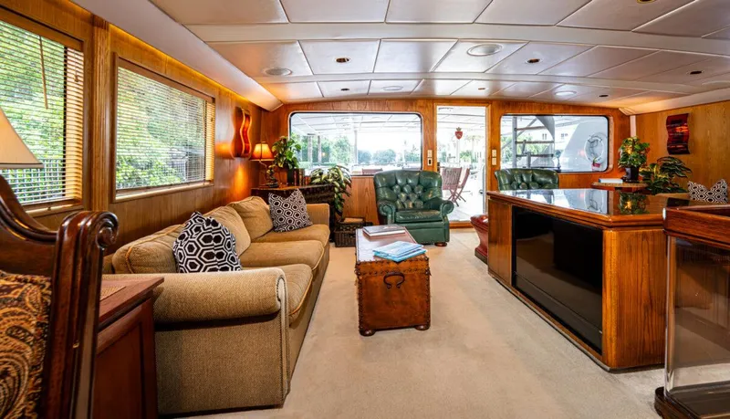 Le Montrachet Yacht Photos Pics Luxurious 1986 Broward Flybridge yacht interior with elegant furnishings and large windows.
