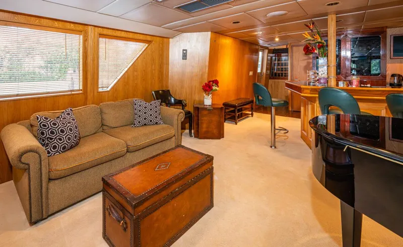 Le Montrachet Yacht Photos Pics Luxurious 1986 Broward Flybridge yacht interior with cozy seating and elegant decor.