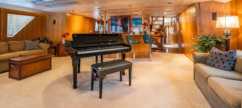 Le Montrachet Yacht Photos Pics Luxurious 1986 Broward Flybridge yacht interior with piano and elegant seating area.