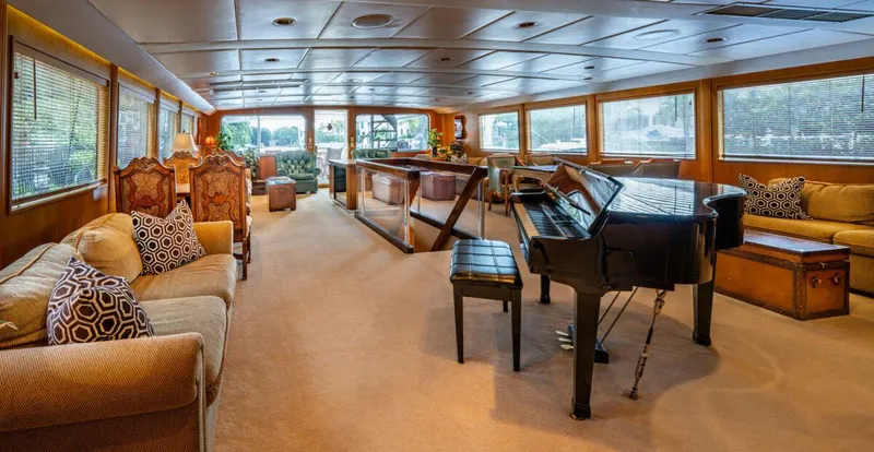 Le Montrachet Yacht Photos Pics Luxurious 1986 Broward Flybridge yacht interior with grand piano and elegant seating.