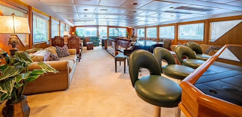 Le Montrachet Yacht Photos Pics Luxurious 1986 Broward Flybridge yacht interior with elegant seating and large windows.