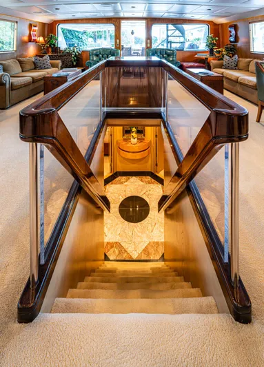 Le Montrachet Yacht Photos Pics Luxurious 1986 Broward Flybridge yacht interior with elegant staircase and plush seating.