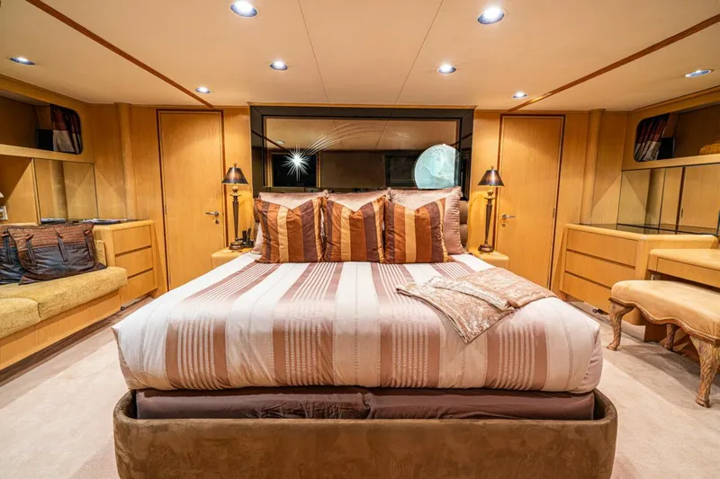 Le Montrachet Yacht Photos Pics Luxurious 1986 Broward Flybridge yacht bedroom with elegant decor and ambient lighting.