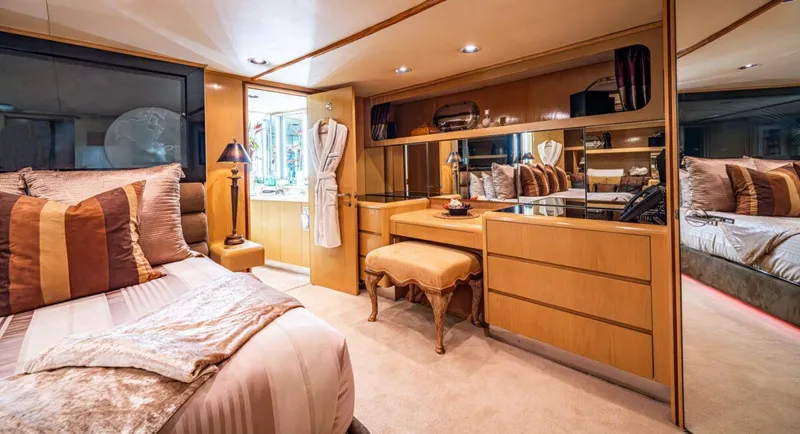 Le Montrachet Yacht Photos Pics Luxurious 1986 Broward Flybridge yacht bedroom with elegant decor and ample storage.