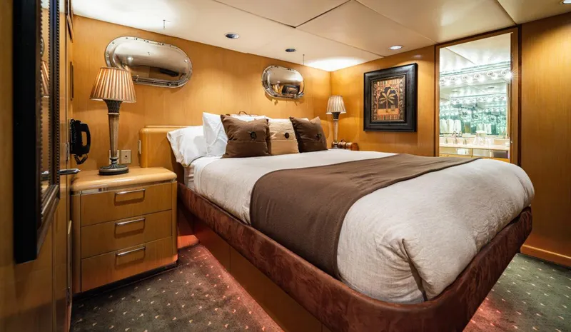 Le Montrachet Yacht Photos Pics Luxurious 1986 Broward Flybridge yacht bedroom with elegant decor and ambient lighting.