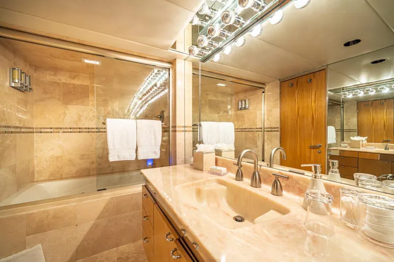 Le Montrachet Yacht Photos Pics Luxurious bathroom in 1986 Broward Flybridge yacht with marble sink and glass shower.