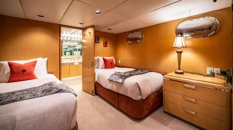 Le Montrachet Yacht Photos Pics Luxurious 1986 Broward Flybridge yacht bedroom with twin beds and elegant decor.