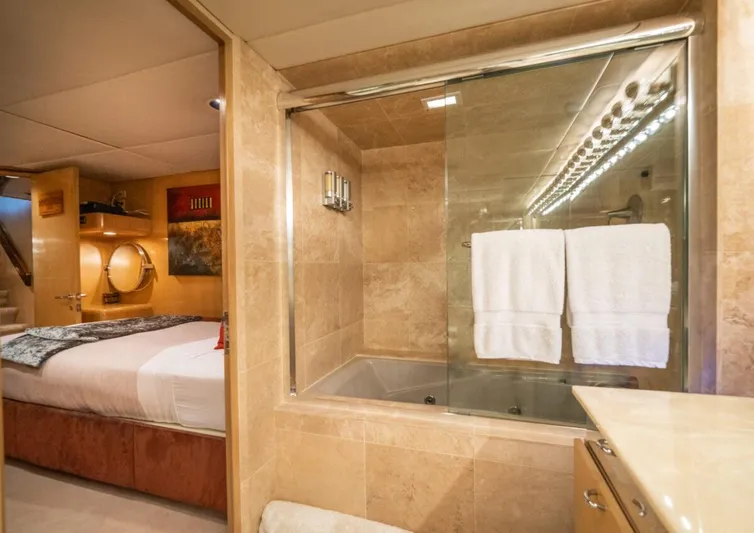 Le Montrachet Yacht Photos Pics Luxurious 1986 Broward Flybridge yacht interior with elegant bedroom and bathroom.