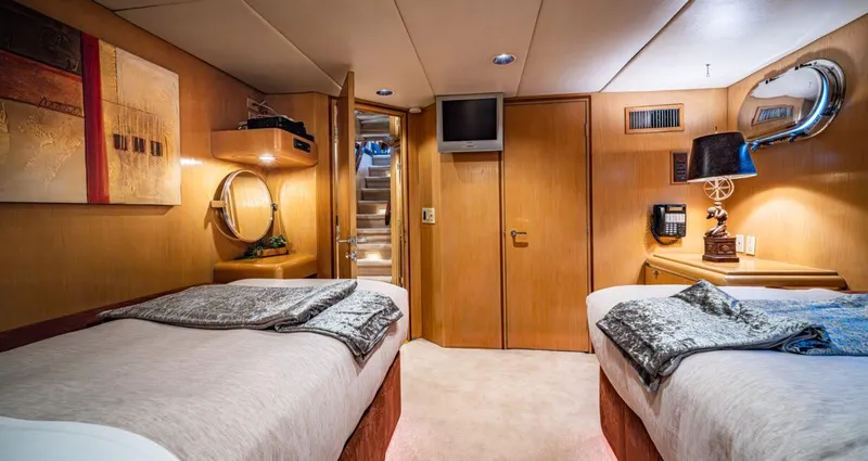 Le Montrachet Yacht Photos Pics Luxurious 1986 Broward Flybridge yacht cabin with twin beds and elegant decor.