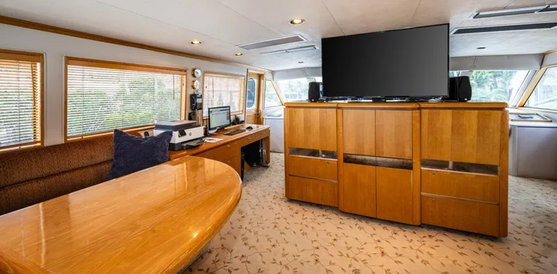 Le Montrachet Yacht Photos Pics Luxurious 1986 Broward Flybridge yacht interior with wood furnishings and modern electronics.