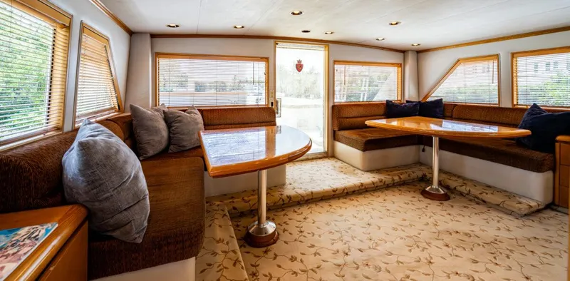 Le Montrachet Yacht Photos Pics Luxurious 1986 Broward Flybridge yacht interior with plush seating and elegant decor.