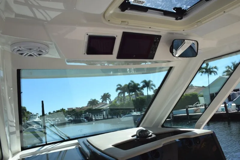 Erika Ray Yacht Photos Pics Hardtop has integral stereo, lighting, vent hatch, Engine and SeaKeeper screens above