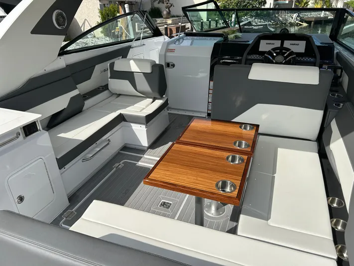 2024 Cruisers Yachts 34 Gls Ob Yacht Photos Pics 2024 Cruisers Yachts 34 GLS OB interior with seating and wooden table.