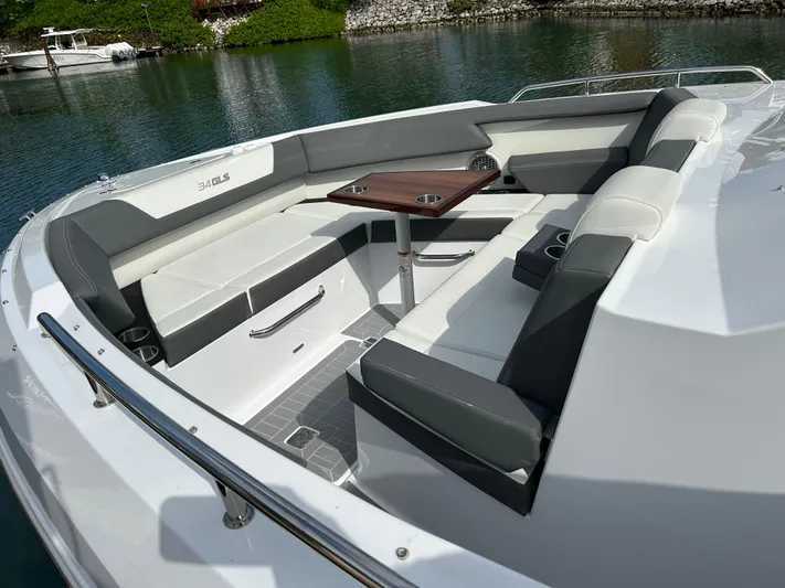 2024 Cruisers Yachts 34 Gls Ob Yacht Photos Pics 2024 Cruisers Yachts 34 GLS OB, luxurious seating area with table, docked by serene waters.