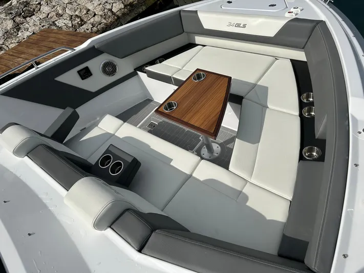2024 Cruisers Yachts 34 Gls Ob Yacht Photos Pics 2024 Cruisers Yachts 34 GLS OB interior with luxurious seating and wooden table.