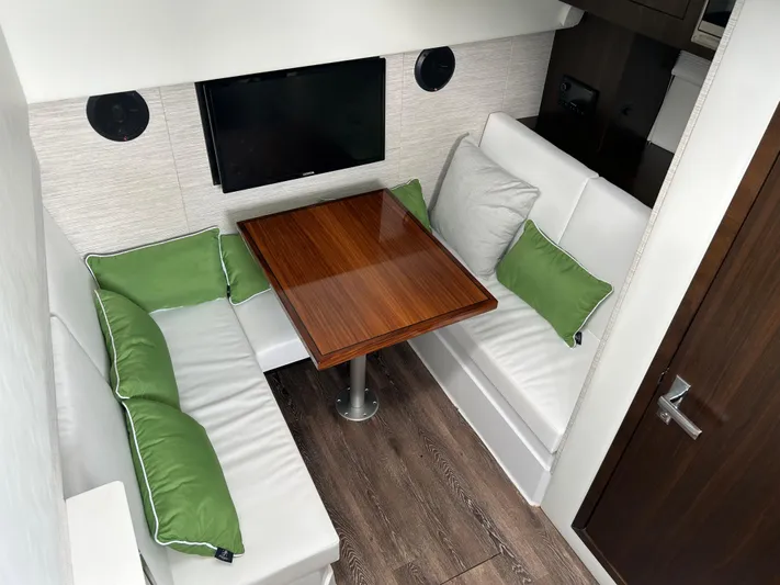 2024 Cruisers Yachts 34 Gls Ob Yacht Photos Pics 2024 Cruisers Yachts 34 GLS OB interior with cozy seating and wooden table.