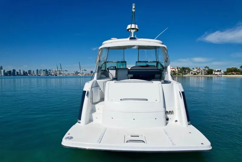  Yacht Photos Pics 2006 Formula 40 Performance Cruiser on calm water with city skyline in background.
