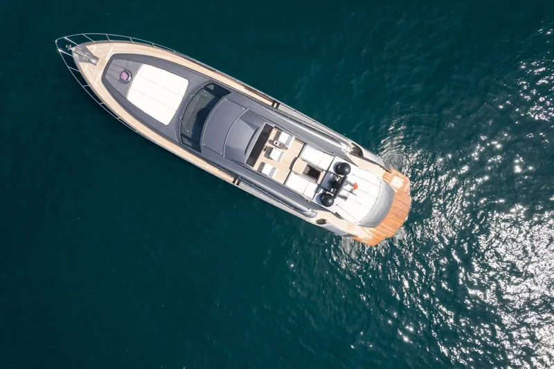 Mylo Yacht Photos Pics Aerial view of 2014 Pershing 74 yacht on sparkling blue water.