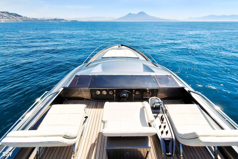 Mylo Yacht Photos Pics Luxurious 2014 Pershing 74 yacht cruising on open sea with scenic mountain view.