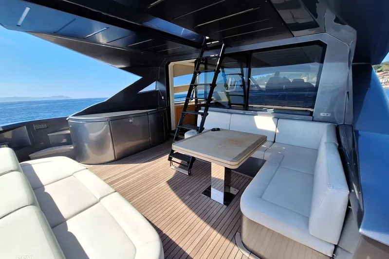 Mylo Yacht Photos Pics Luxurious 2014 Pershing 74 yacht deck with seating, table, and ocean view.