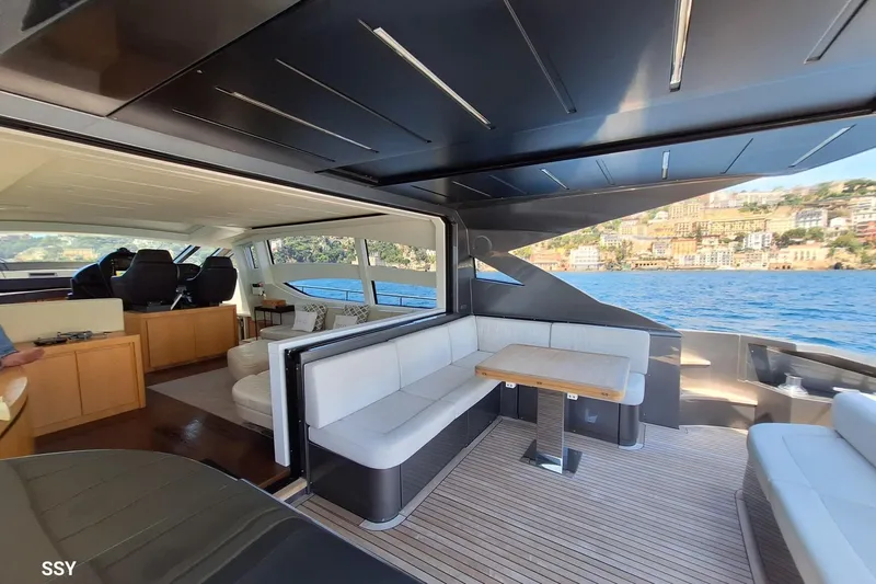 Mylo Yacht Photos Pics Luxurious interior of 2014 Pershing 74 yacht with elegant seating and scenic ocean view.