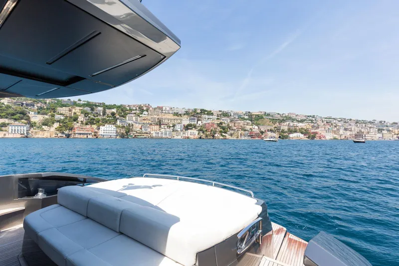 Mylo Yacht Photos Pics Luxurious 2014 Pershing 74 yacht with scenic coastal view in the background.