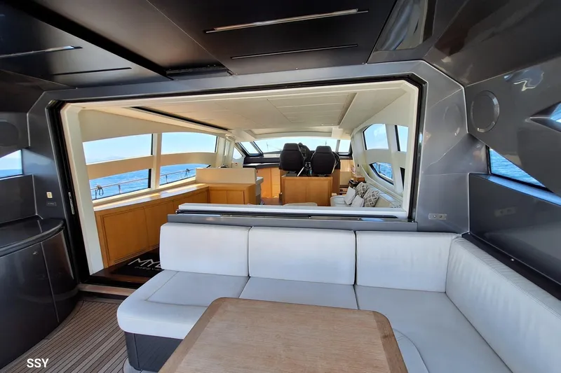 Mylo Yacht Photos Pics Luxurious interior of 2014 Pershing 74 yacht with modern seating and ocean view.