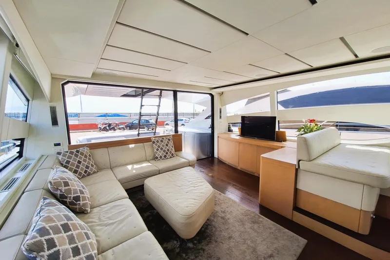 Mylo Yacht Photos Pics Luxurious interior of a 2014 Pershing 74 yacht with modern furnishings and large windows.