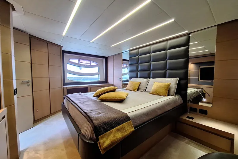 Mylo Yacht Photos Pics Luxurious bedroom interior of 2014 Pershing 74 yacht with modern design and elegant lighting.