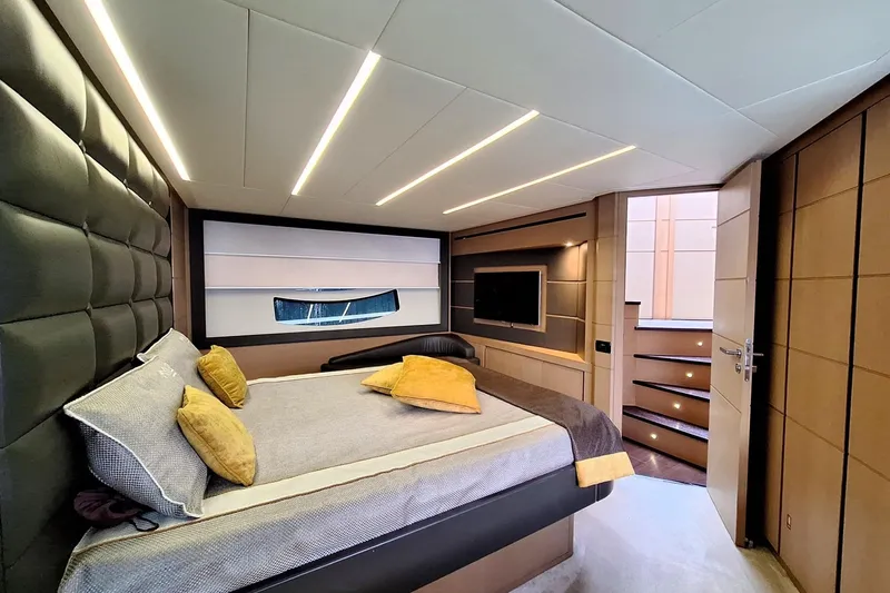 Mylo Yacht Photos Pics Luxurious bedroom interior of 2014 Pershing 74 yacht with modern design and ambient lighting.