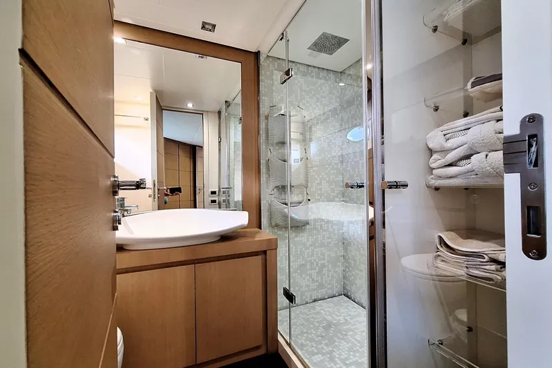 Mylo Yacht Photos Pics Luxurious bathroom in 2014 Pershing 74 yacht with modern fixtures and glass shower.