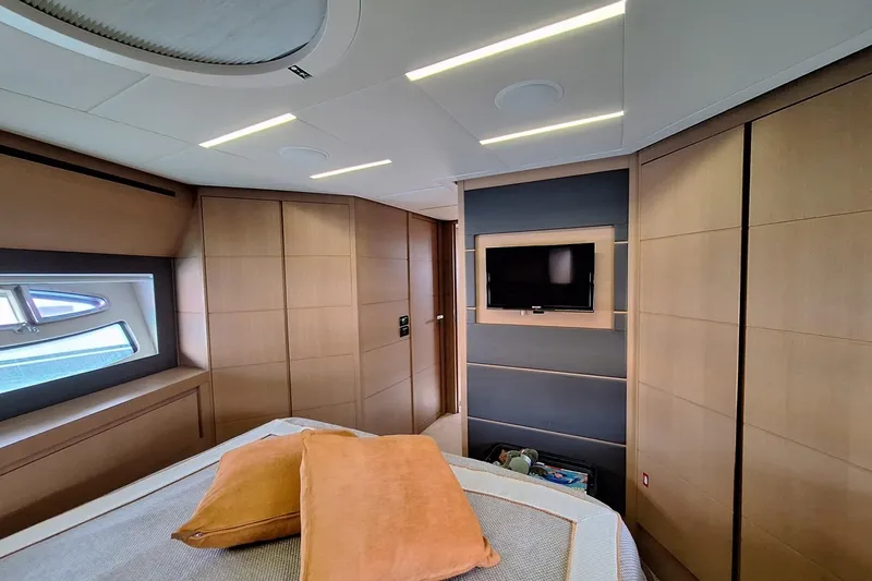 Mylo Yacht Photos Pics Luxurious interior of a 2014 Pershing 74 yacht cabin with modern design and TV.