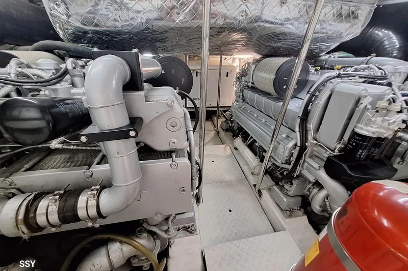 Mylo Yacht Photos Pics Engine room of 2014 Pershing 74 yacht, showcasing powerful machinery and components.