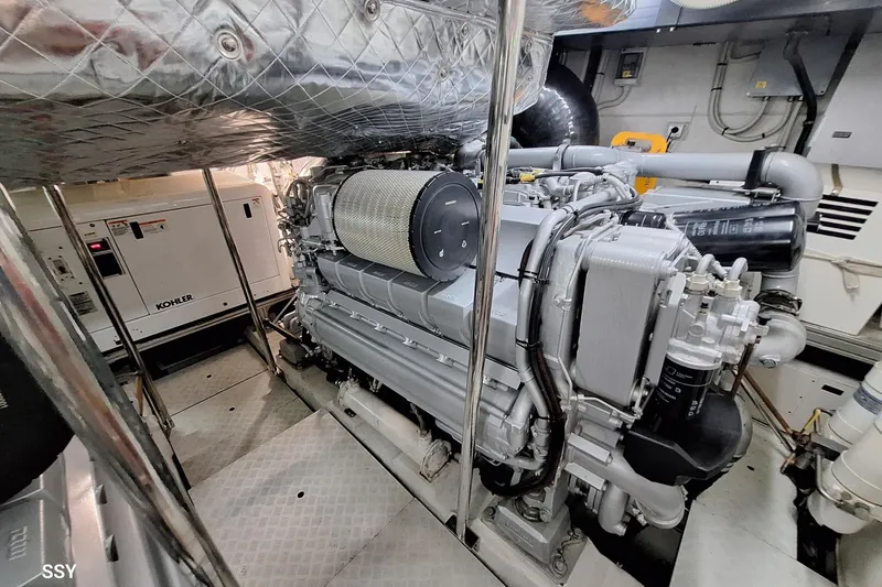 Mylo Yacht Photos Pics Engine room of a 2014 Pershing 74 yacht, featuring a Kohler generator.